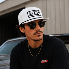 Load image into Gallery viewer, Man wearing a white cap with BBS logo and black sunglasses with 'BBS' branding on his shirt.